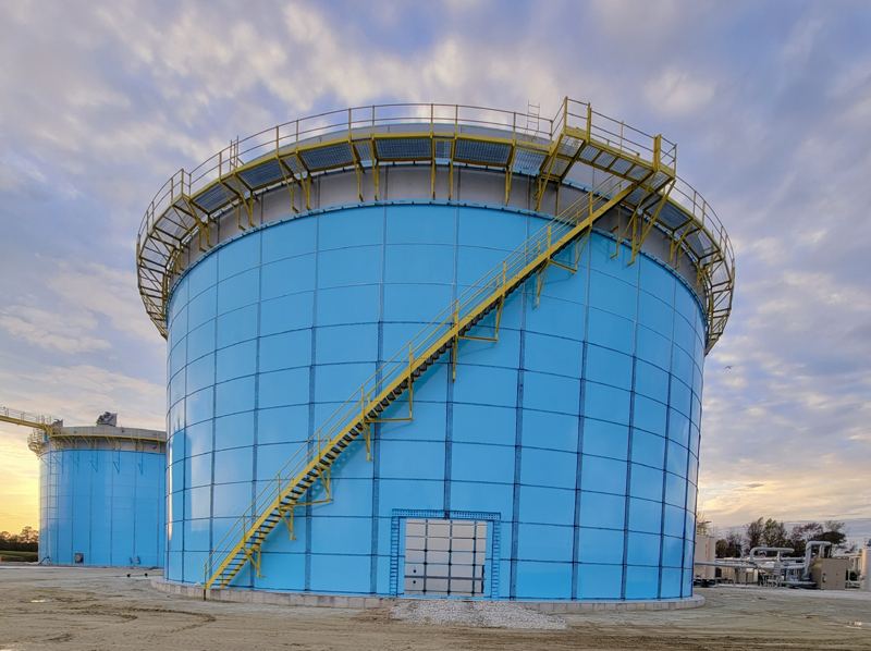 Two-million-gallon epoxy-coated bolted steel anaerobic digester tank with stainless steel top ring, aluminum deck, and stair access