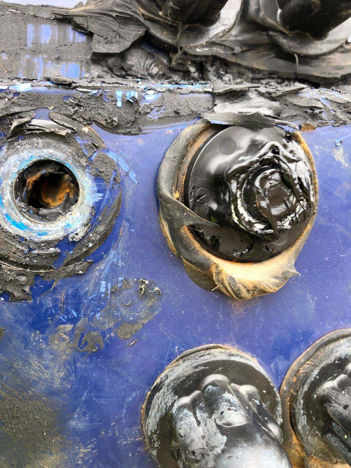 Corroded tank penetration with over-applied sealant repair