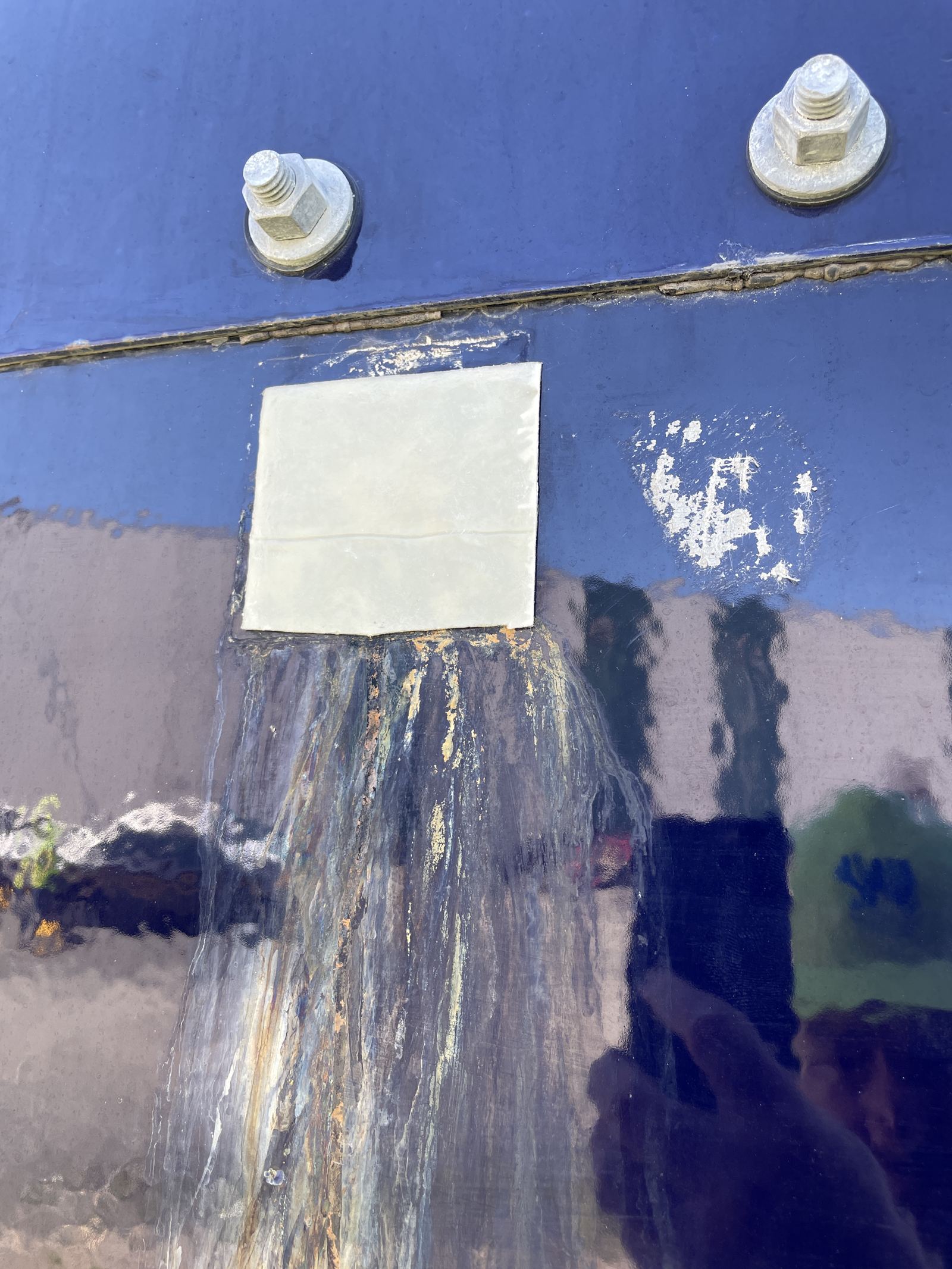 Tank seam with a patch repair and undercutting corrosion along the joint