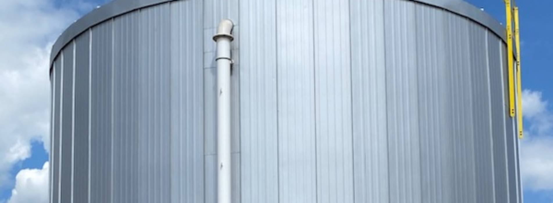 Completed vertical standing seam insulation jacketing on a large storage tank