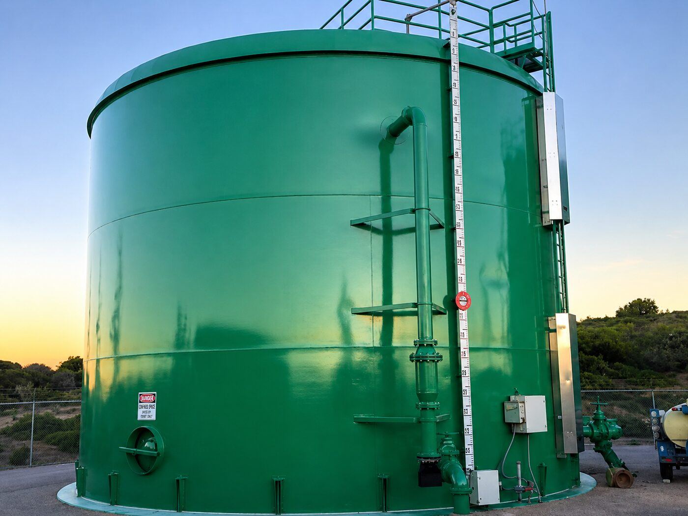 Finished green coated steel tank with access ladder and exterior appurtenances installed