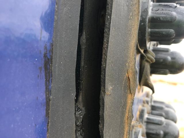 Gap opened in the sealant of a bolted panel seam beside the bolt caps