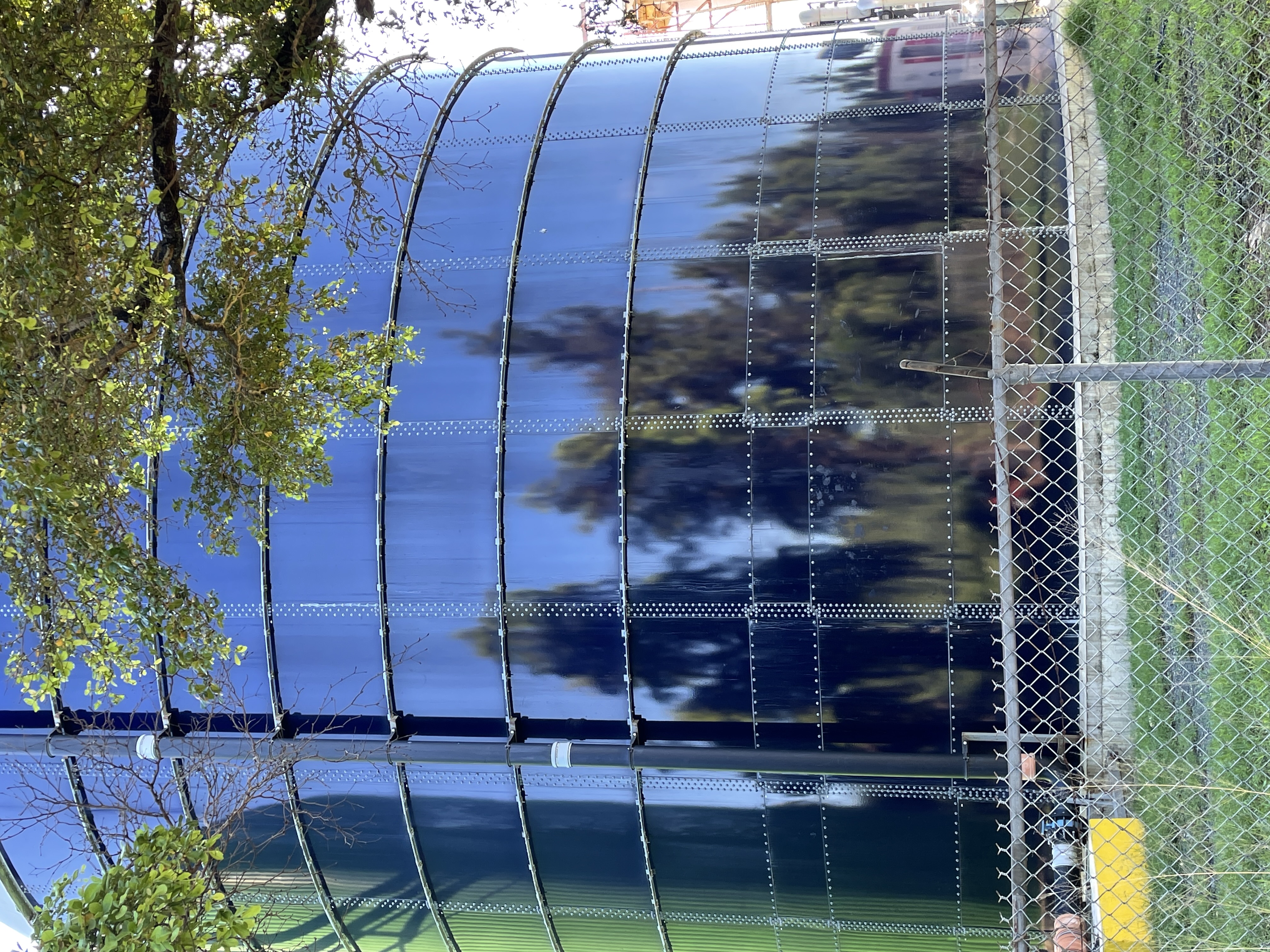 Technician inspecting the exterior shell of a bolted steel tank