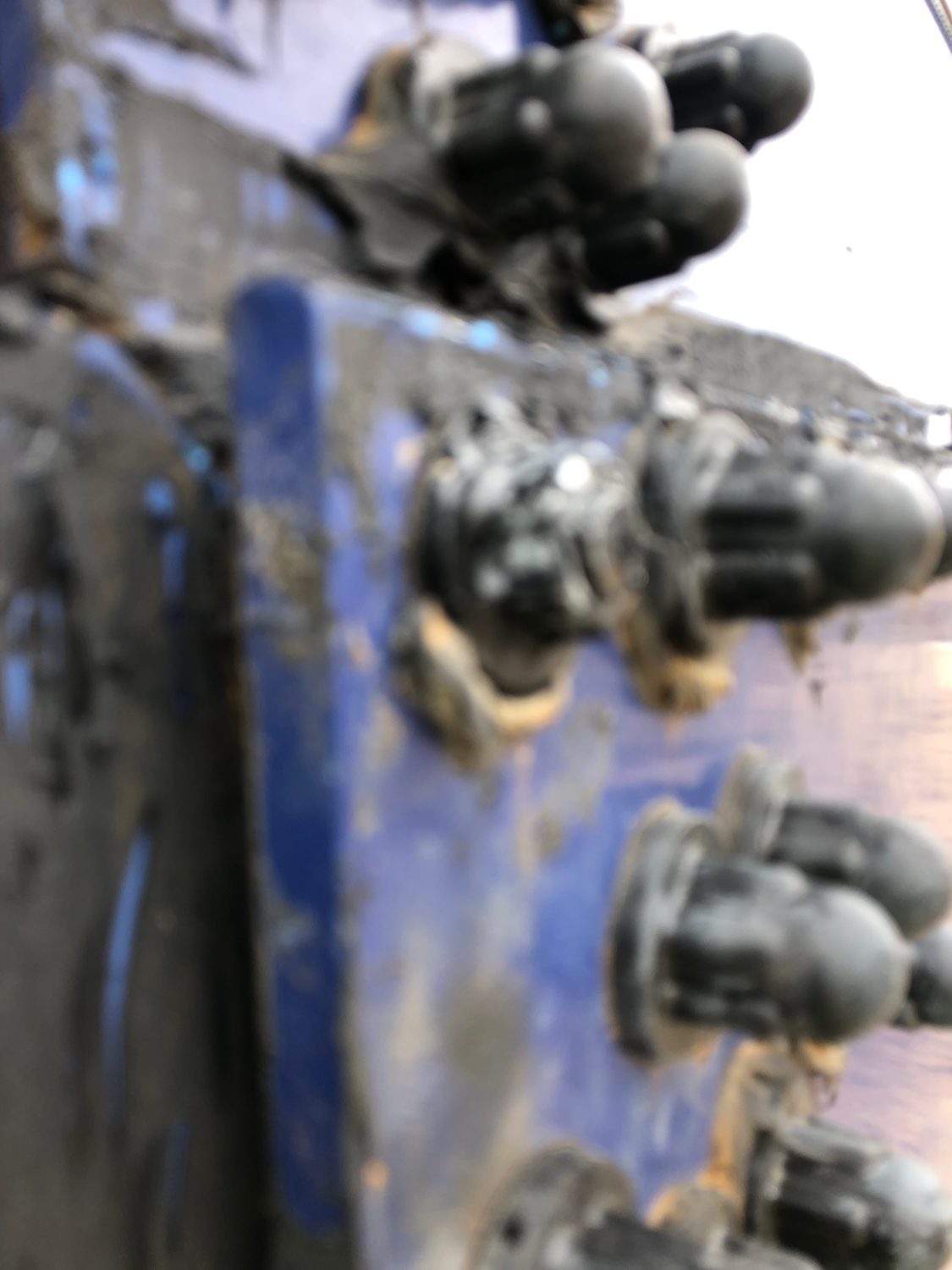 Corroded bolt heads at a bolted tank connection
