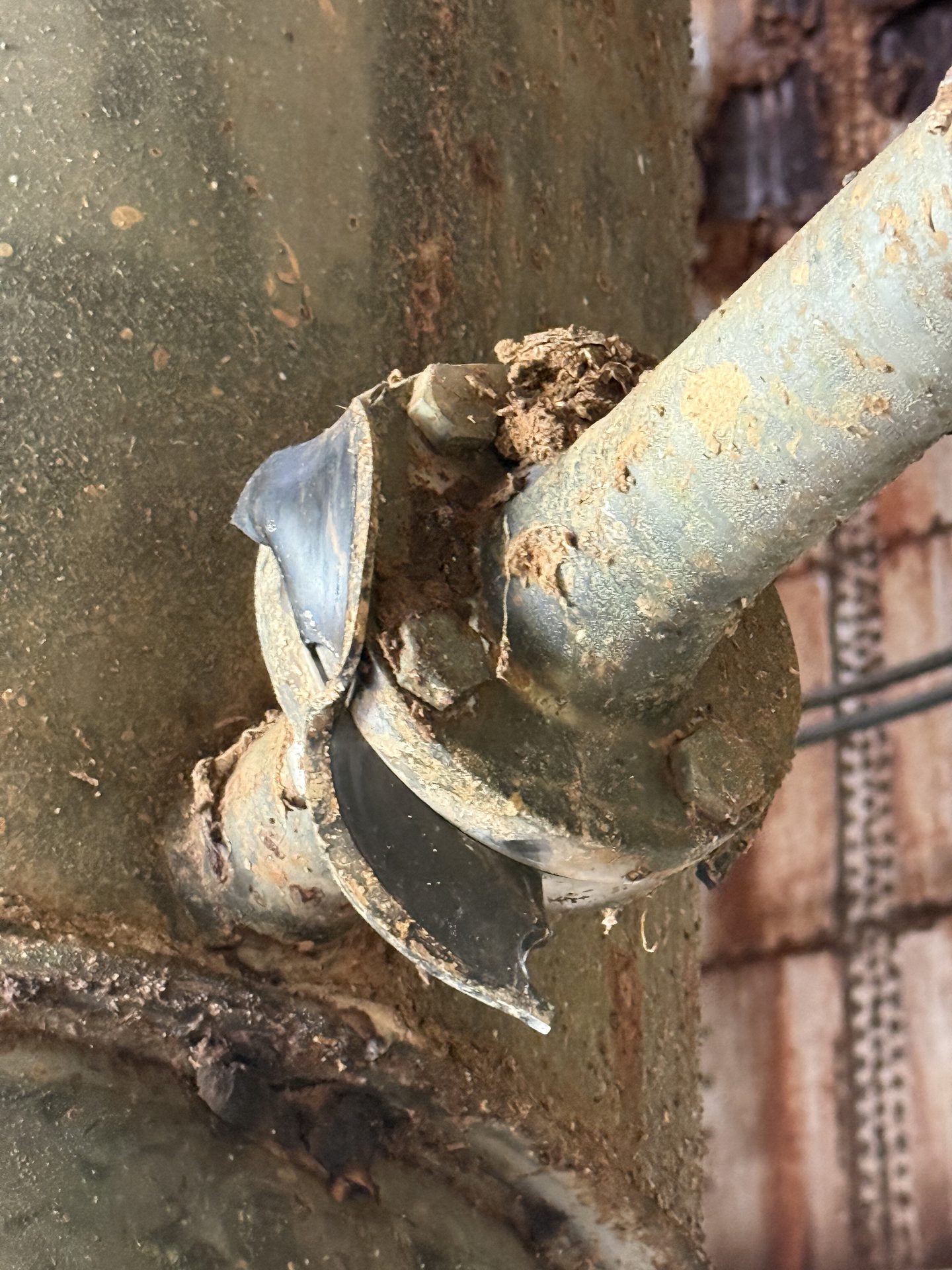 Corroded tank penetration and pipe detail documented during condition assessment