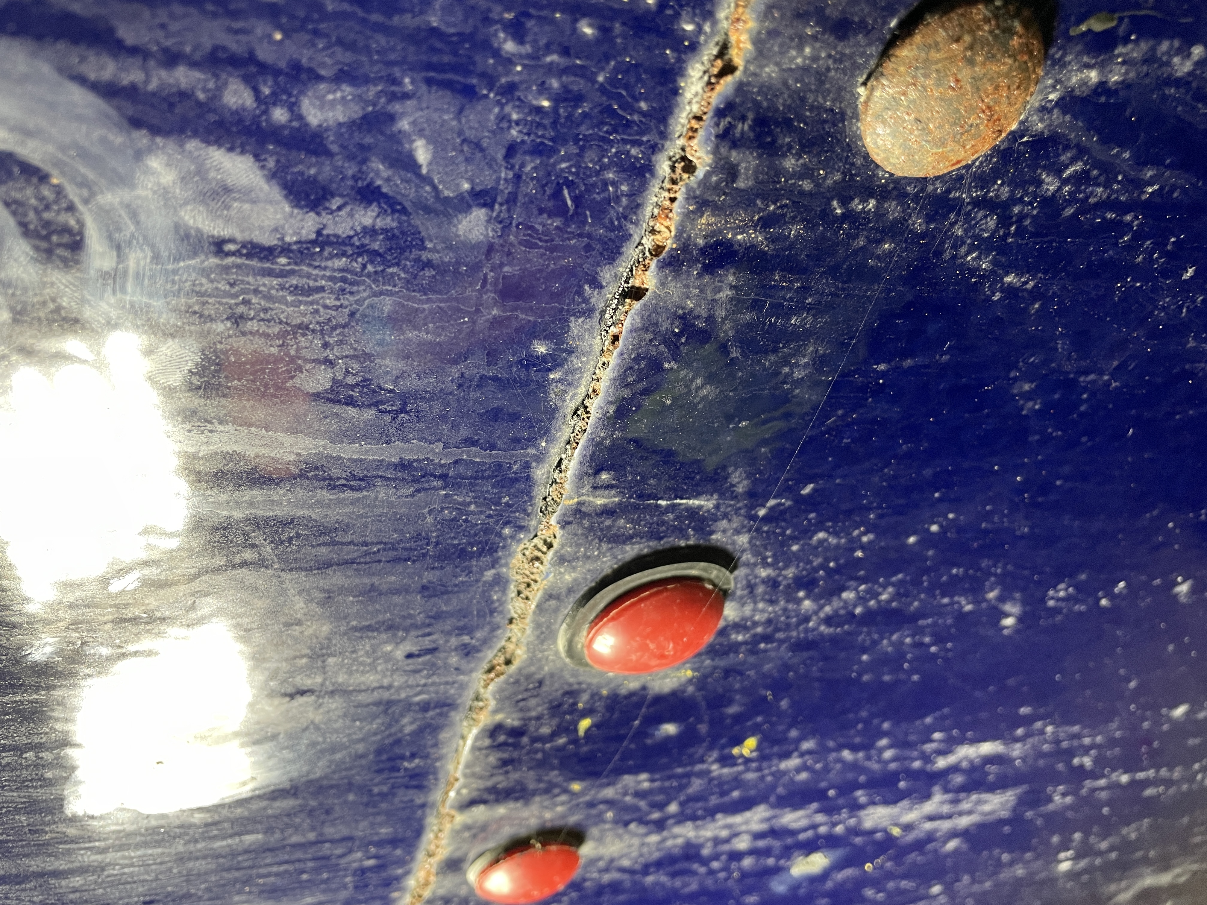 Crack propagating along a coated bolted tank panel seam